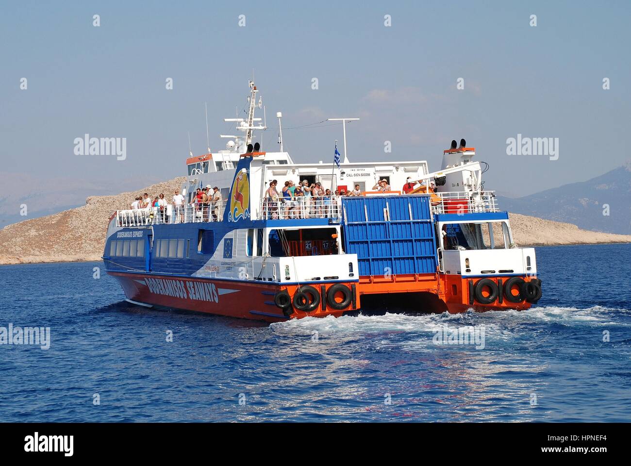 Dodekanisos Seaways catamaran ferry Dodekanisos Express departs Emborio harbour on the Greek island of Halki on July 19, 2016. Stock Photo