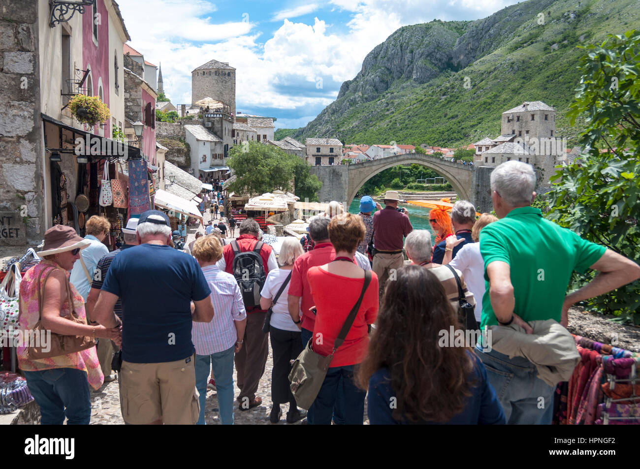 Tourists in Mostar, Bosnia Herzegovina. Looking at Stari Most old bridge in the town Stock Photo