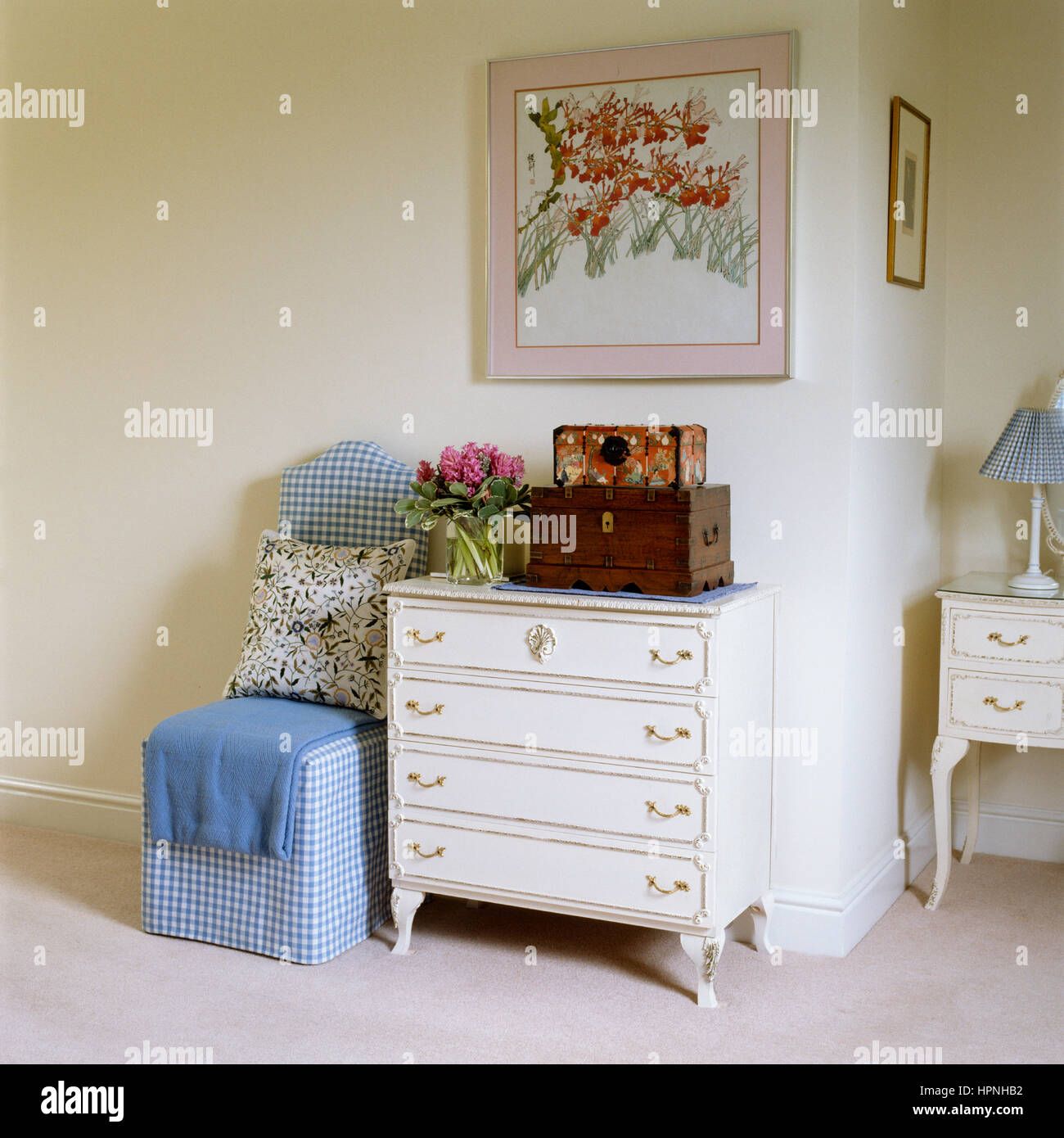 A gingham chair and classic style drawers. Stock Photo