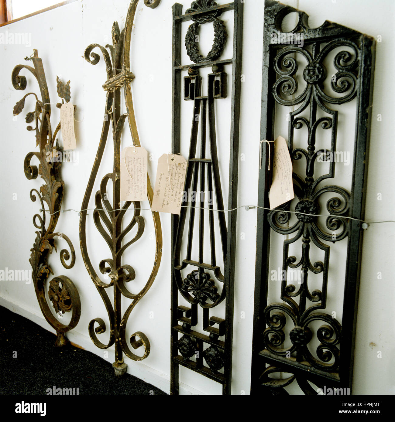 A display of wrought iron grates with labels. Stock Photo