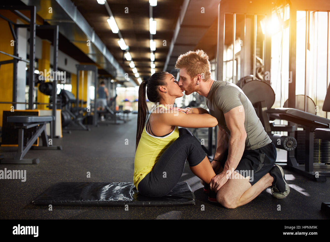 Kiss from fitness partner as prize for well done exercise Stock Photo