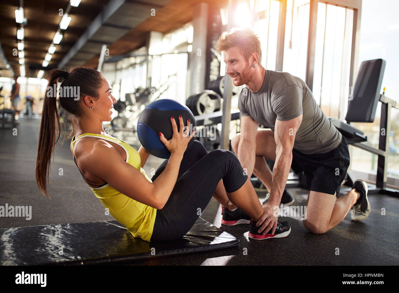 Girl in good shape on fitness training in gym Stock Photo