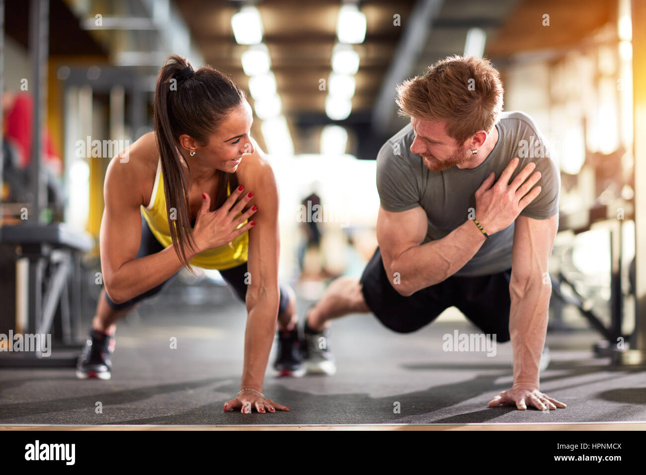 Man and woman strengthen hands at fitness training Stock Photo