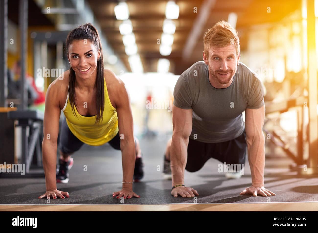 Couple doing exercise for hand muscles at fitness training Stock Photo