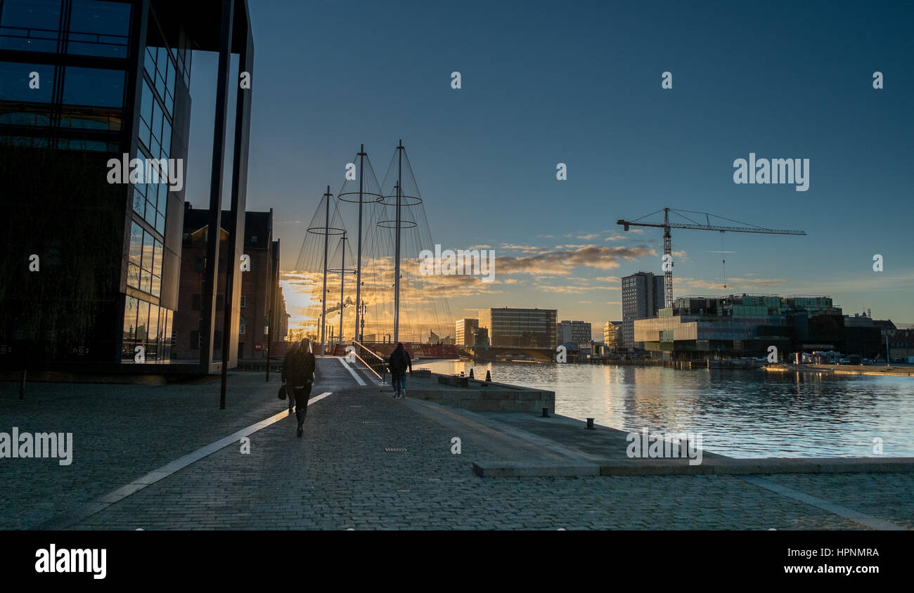 evening sunset,  walking towards Cirkelbroen Bridge Copenhagen,  Blox building under construction in background Stock Photo