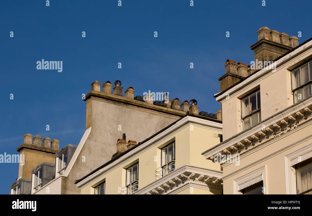 Chimney Pots. A bright blue sky, a winter light, and chimney pots. A day in inner city London Stock Photo