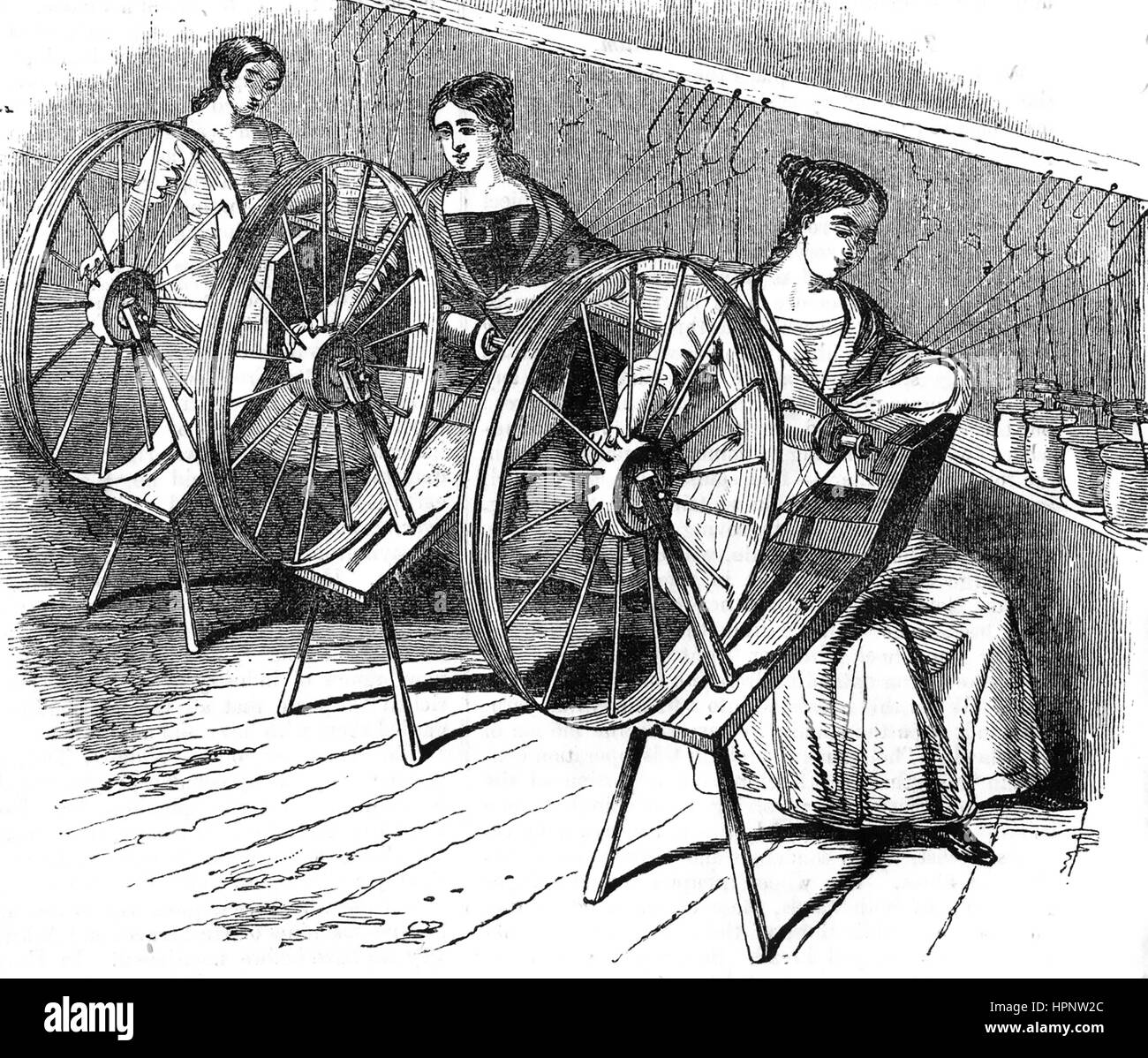 SILK DOUBLING  Engraving about 1850 showing silk from several bobbins being spun into a single stronger thread Stock Photo