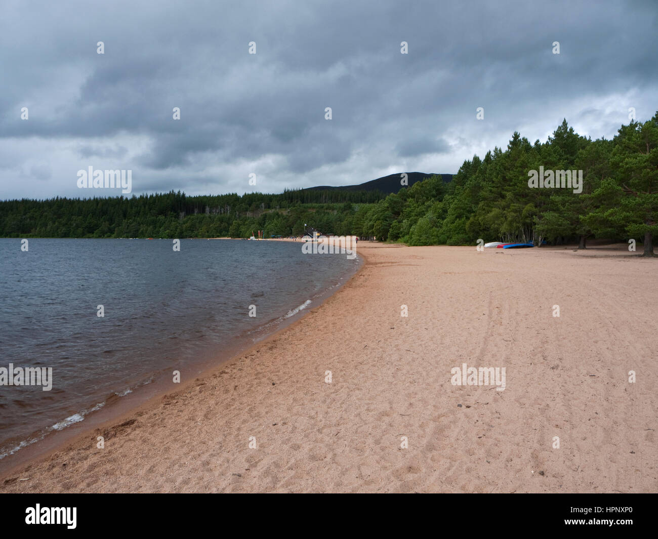 Sandy beach on the shore of Loch Morlich, a popular tourist destination in the Glenmore Forest Park, Cairngorms National Park, Scotland Stock Photo