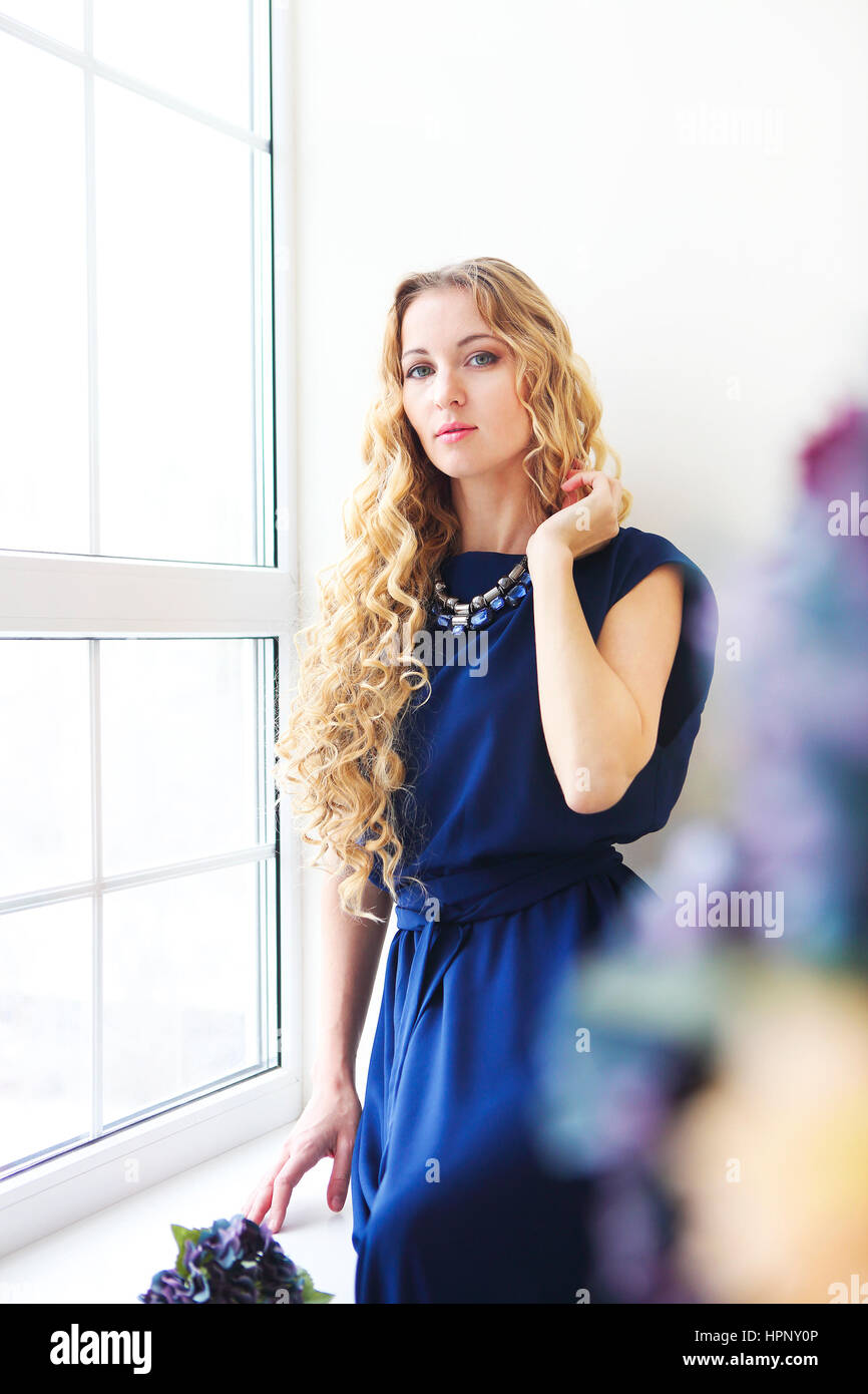 Portrait of the beautiful blond girl with long curly hair Stock Photo ...