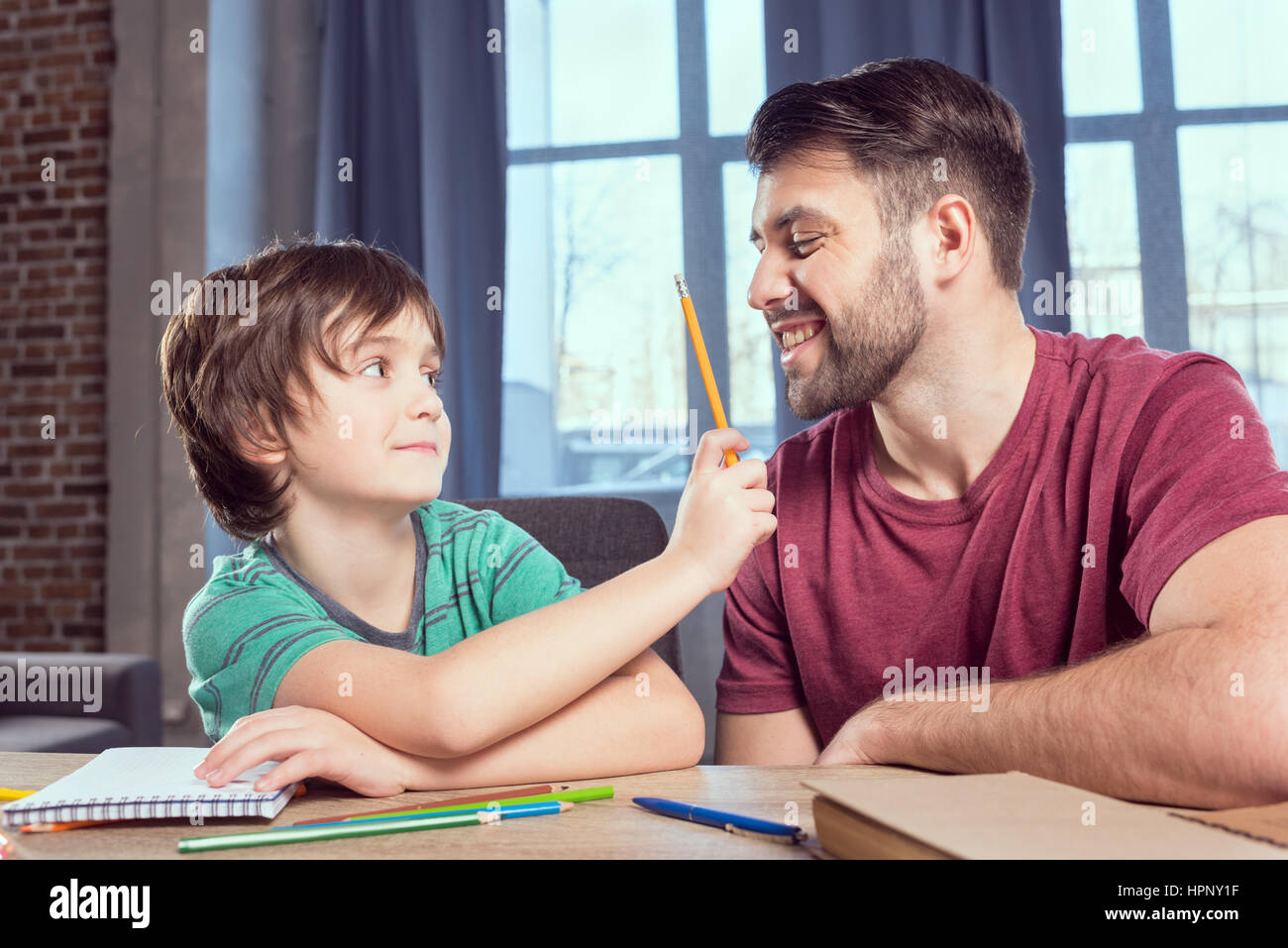 father helping son with homework at home Stock Photo - Alamy