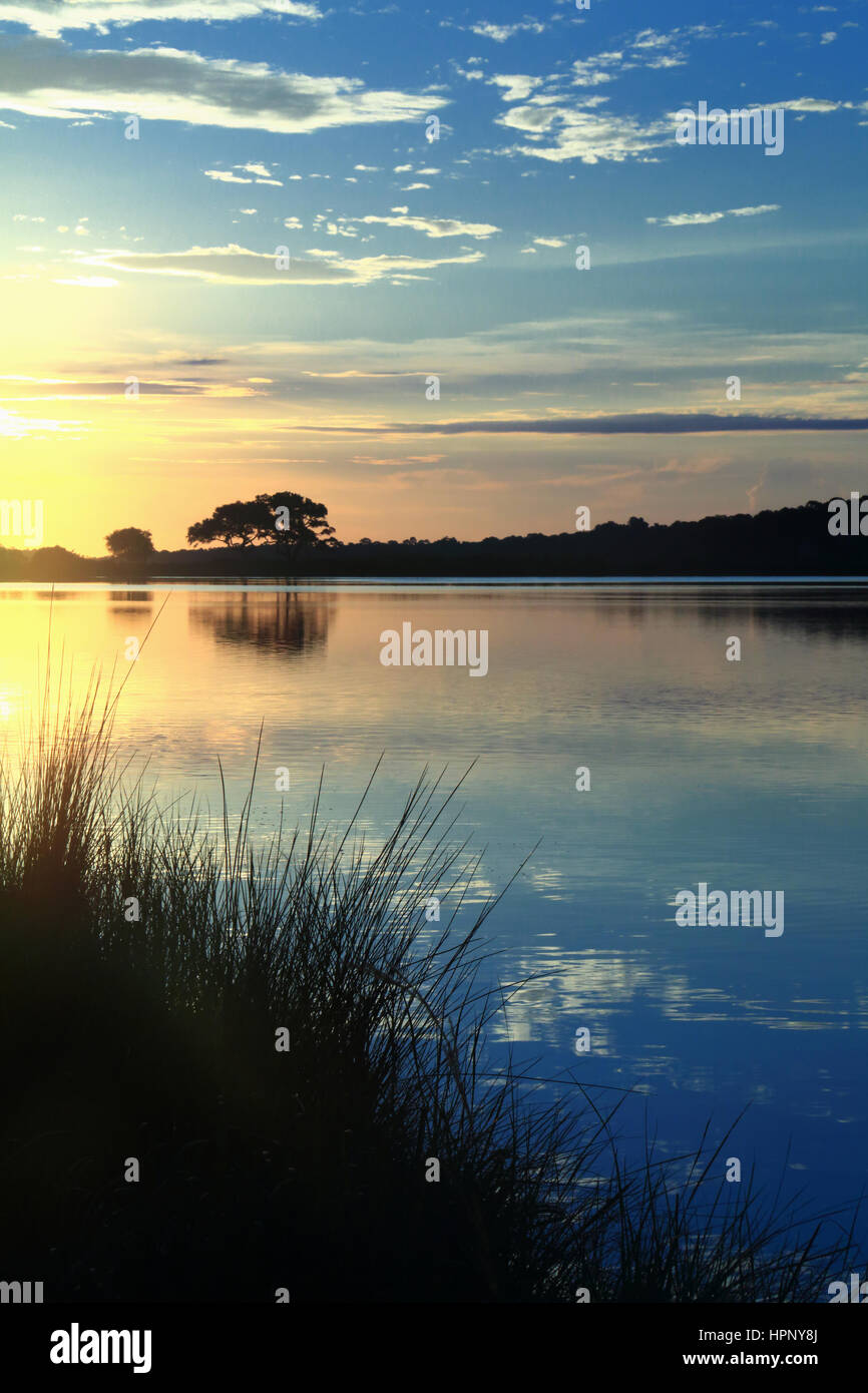 Sunrise over Bass Pond on beautiful Kiawah Island, South Carolina. Bass Pond is surround by marsh and Live Oak trees. Stock Photo