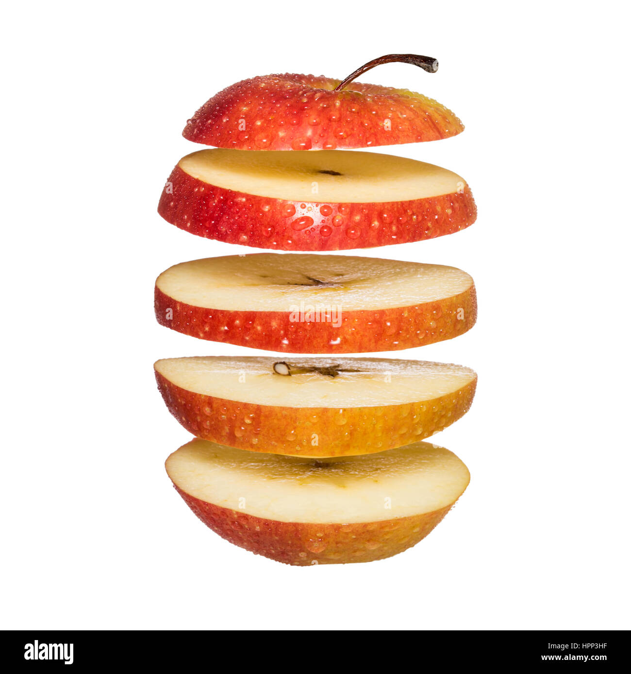 Flying apple. Sliced red apple isolated on white background. Levity fruit floating in the air Stock Photo