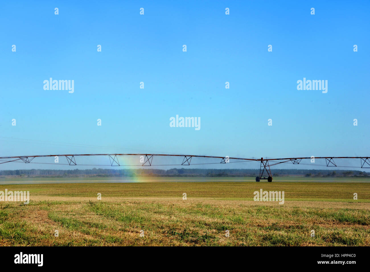 Agriculture irrigation equipment produces spray rainbow.  Field is in Southern Arkansas.  Image could represent the hope for the future of agriculture Stock Photo