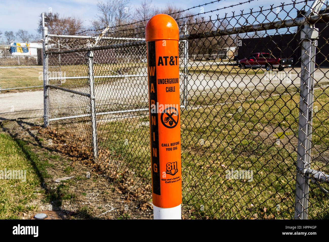 Indianapolis - Circa February 2017: AT&T Warning Post marking underground cables and a note to call 811 before digging I Stock Photo
