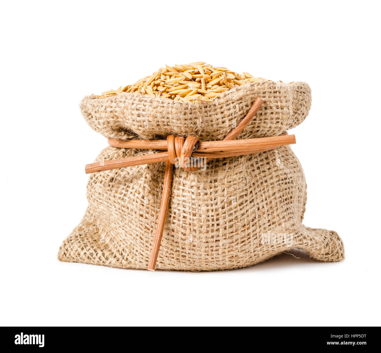 Paddy jasmine rice in sack bag isolated on white background Stock Photo