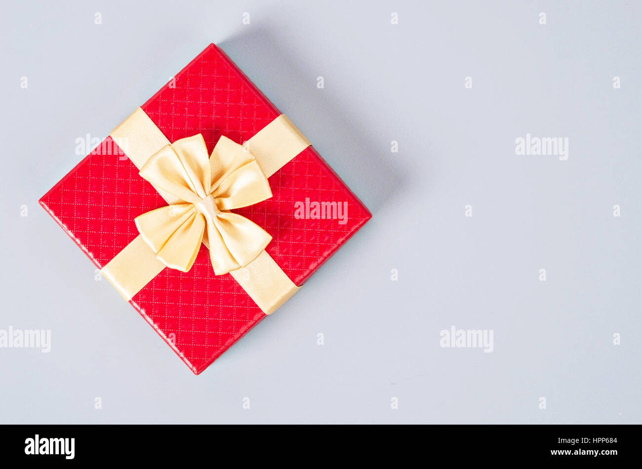 Red gift box on gray color background with empty space Stock Photo - Alamy