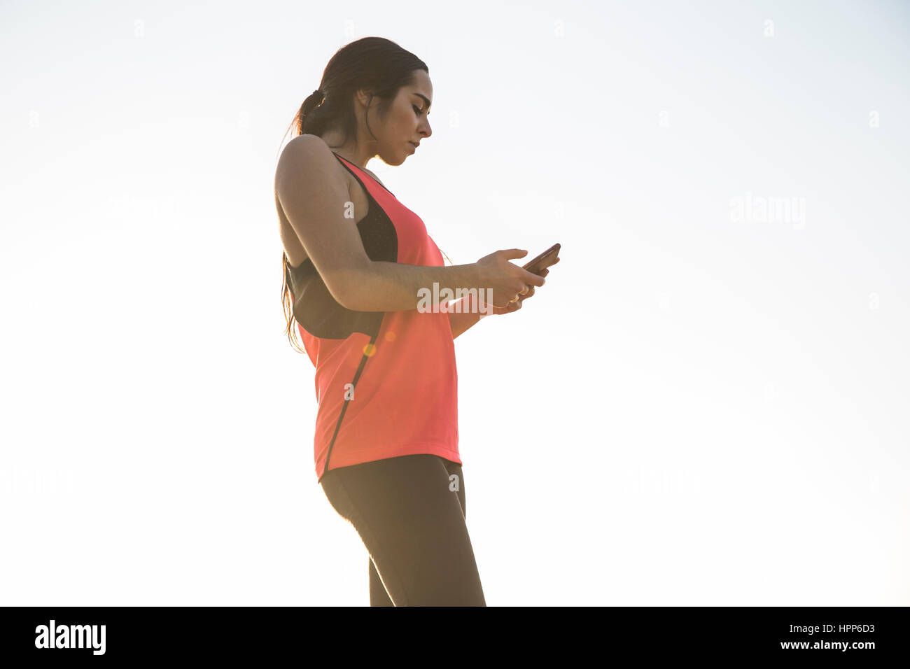 Female athlete using her phone Stock Photo