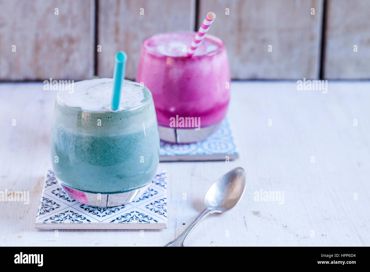 Blue coloured latte with spirulina algae, plant milk, ginger and rice syrup and latte with beetroot juice Stock Photo