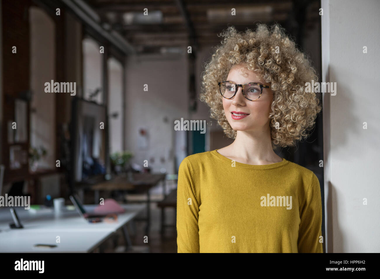 Portrait of smiling woman in office Stock Photo - Alamy
