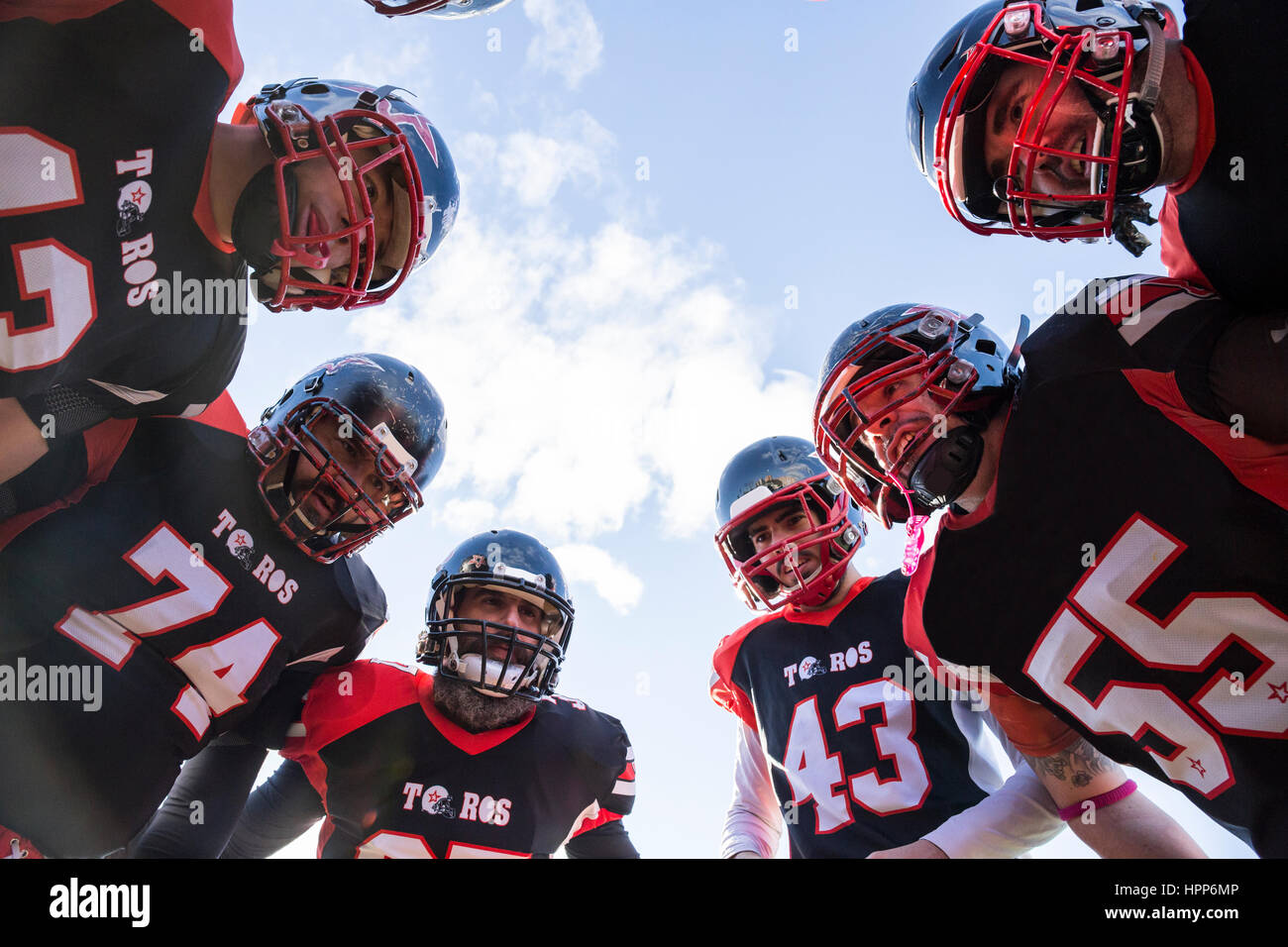 American football players in a huddle Stock Photo