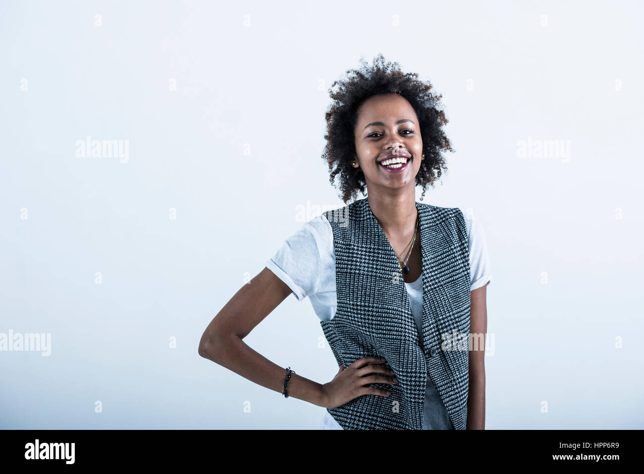 Portrait of laughing woman with hand on her hip Stock Photo - Alamy