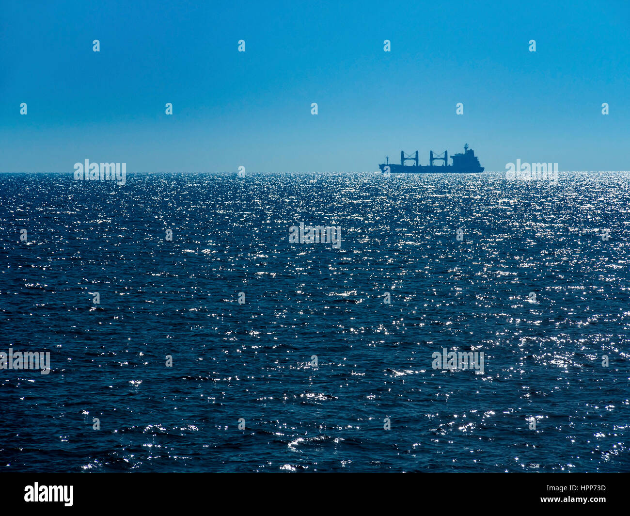 Italy, Sicily, cargo ship on the ocean Stock Photo