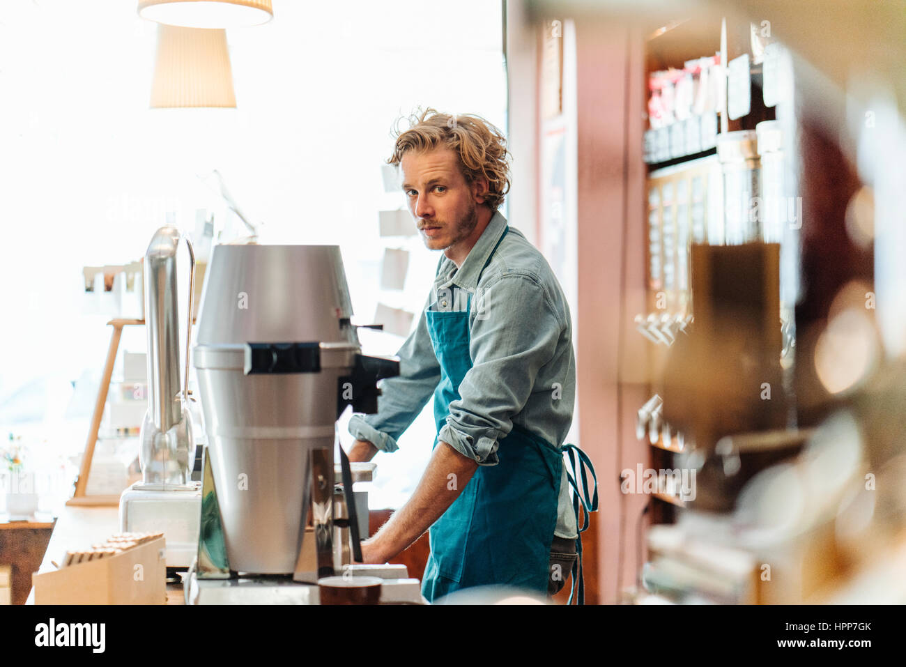 Portrait of coffee roaster at counter in his shop Stock Photo Alamy