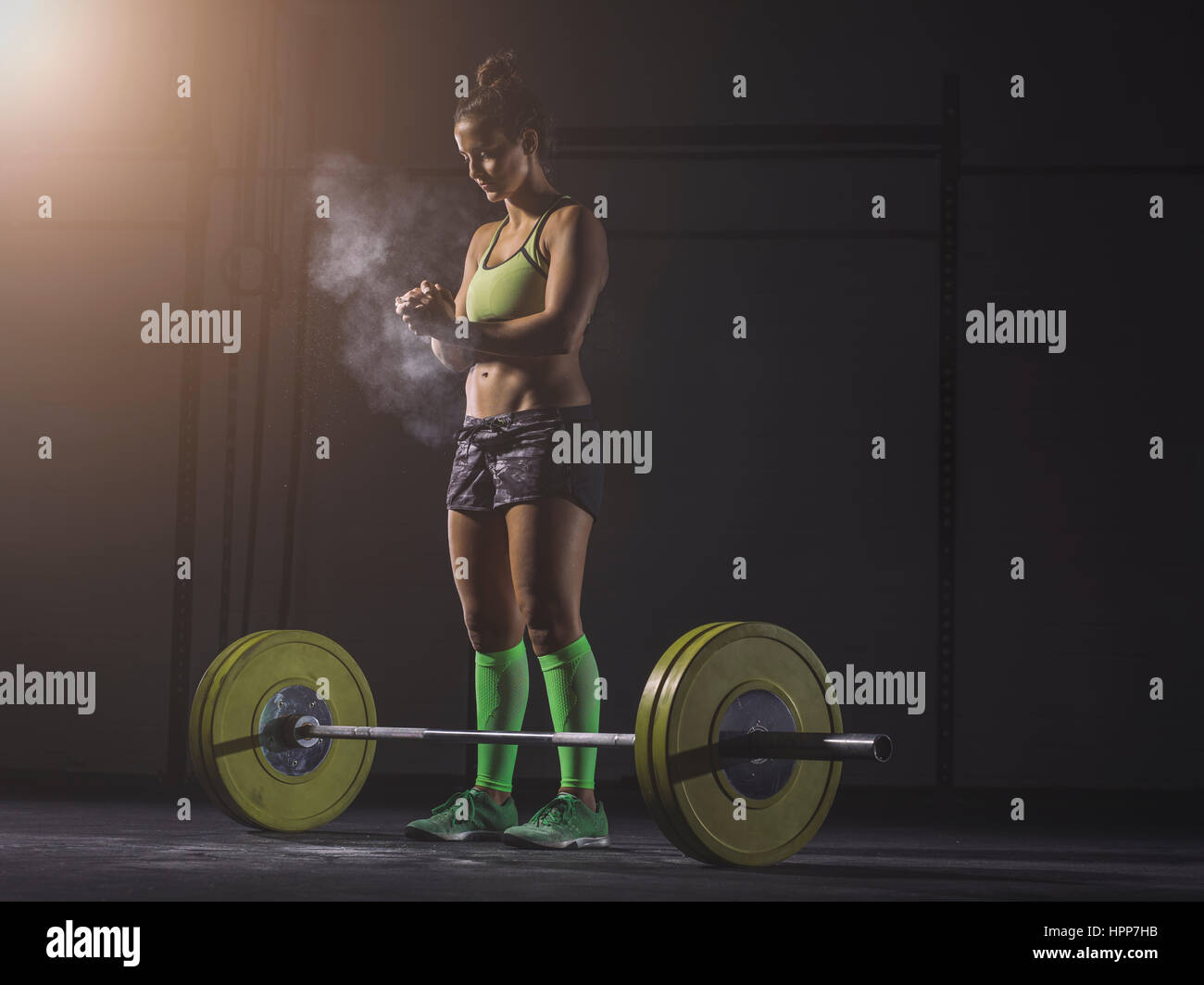Young woman preparing to lift barbell Stock Photo