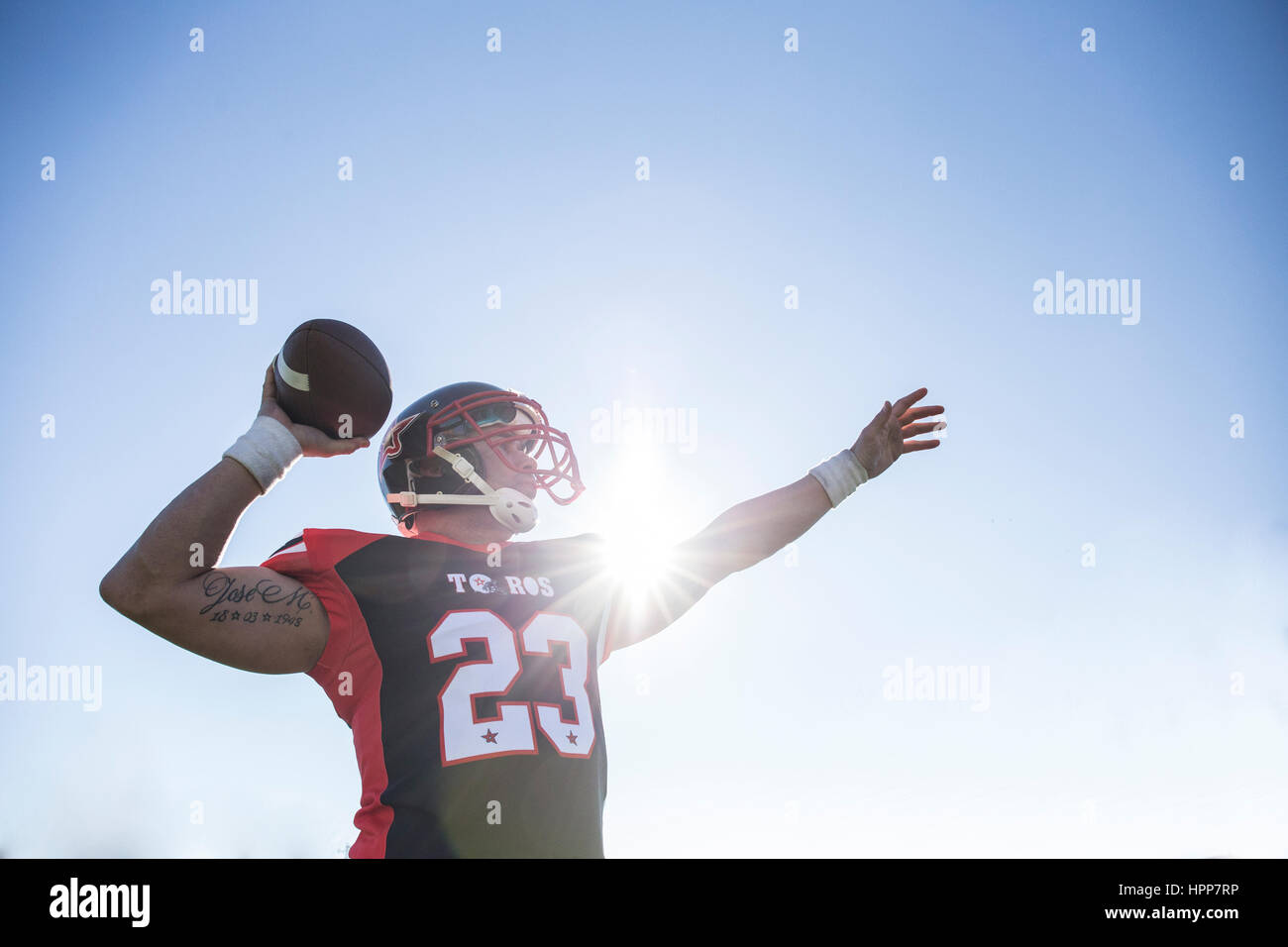 American football player throwing the ball during a match Stock Photo