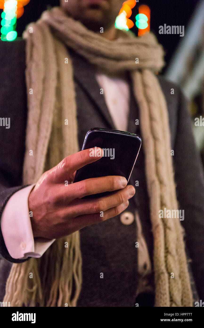 Close-up of man using his cell phone at night Stock Photo