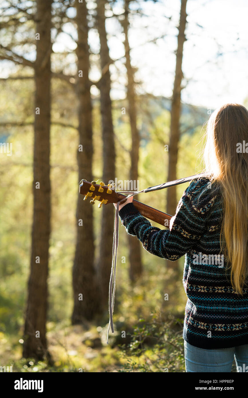 Young woman playing guitar in nature Stock Photo - Alamy