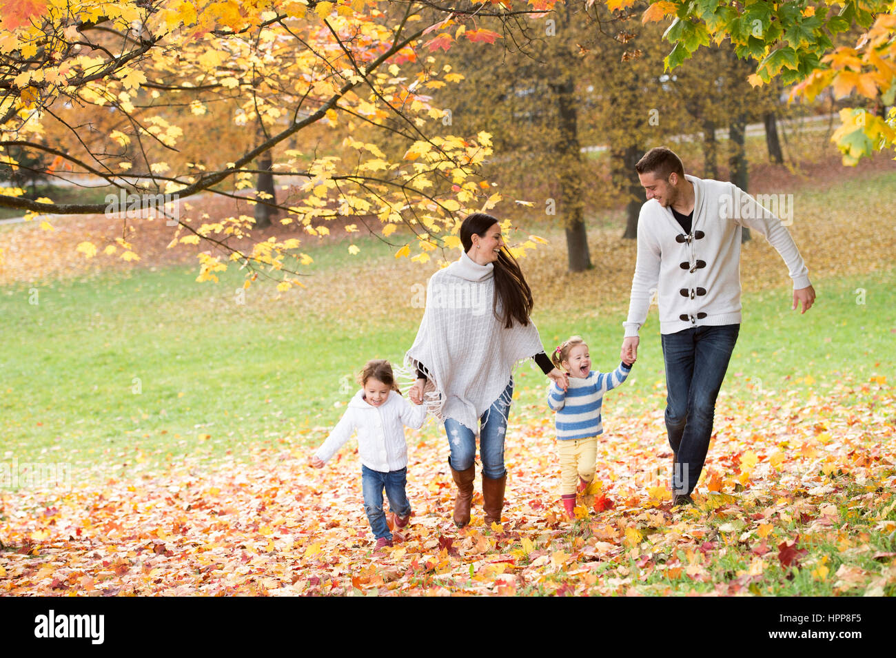 Happy family four walking hi-res stock photography and images - Alamy