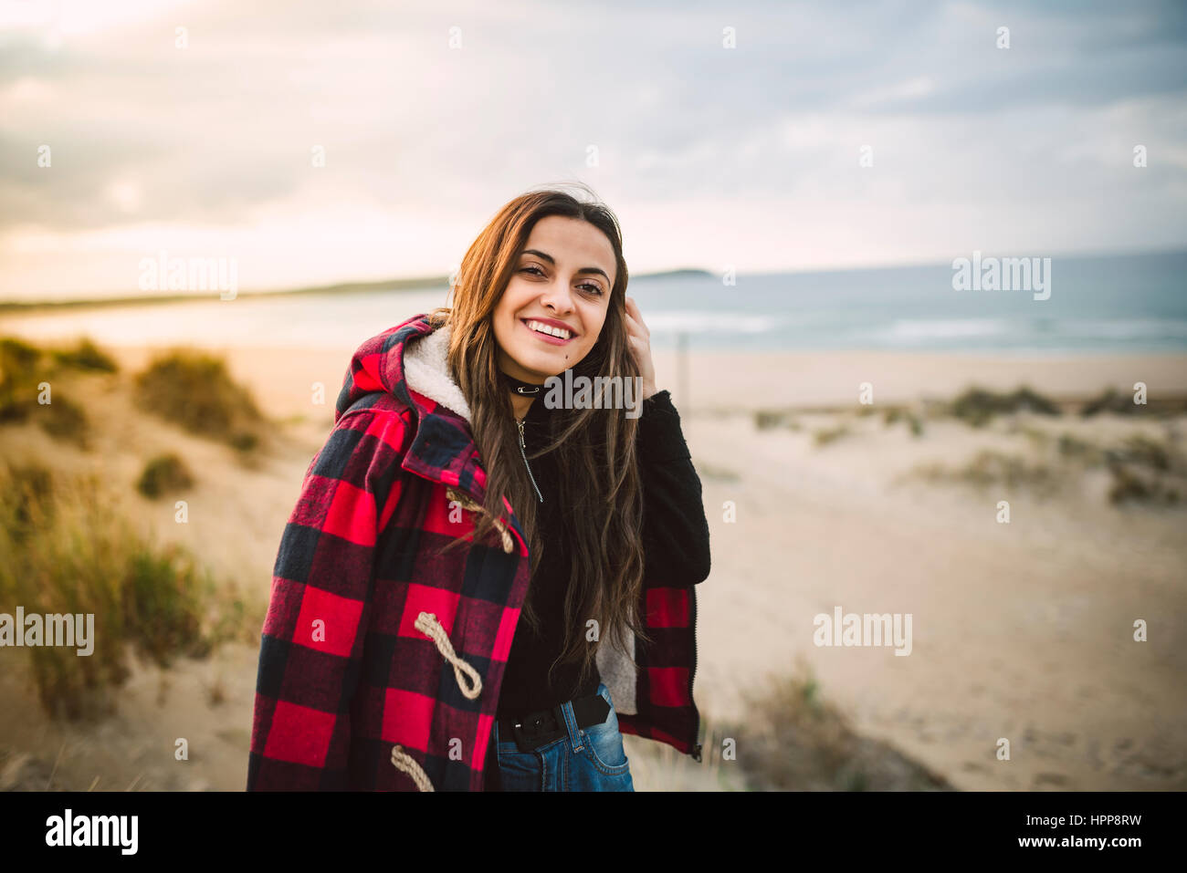 Portrait of relaxed young woman on the beach Stock Photo