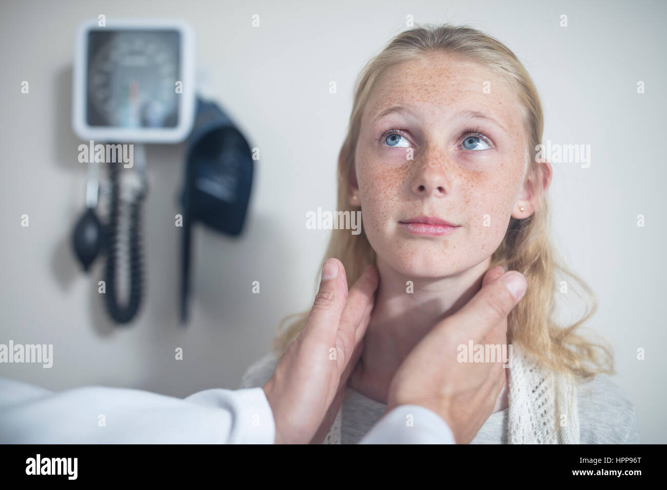 Doctor checking girl's lymph nodes Stock Photo