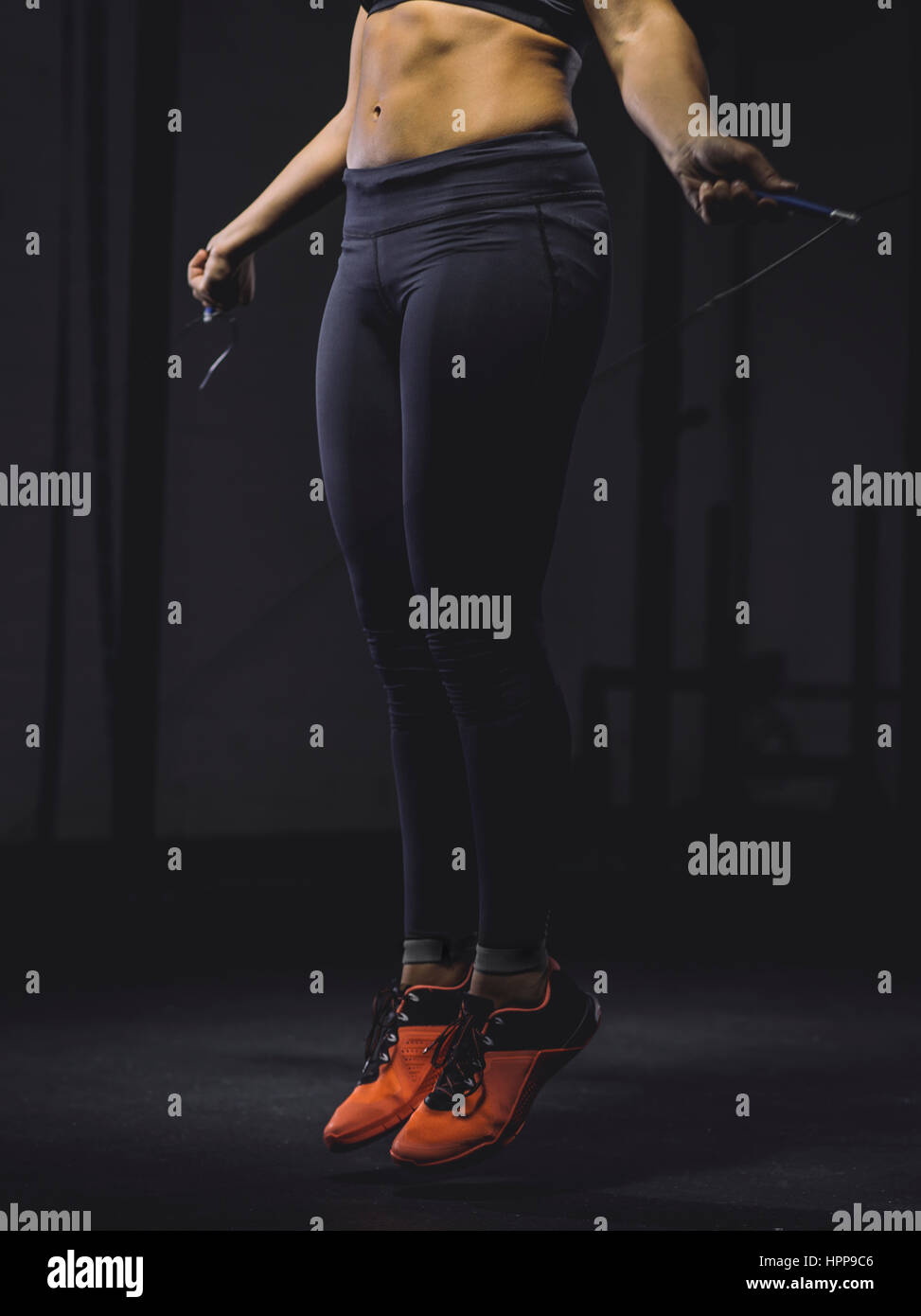 Young woman skipping rope Stock Photo