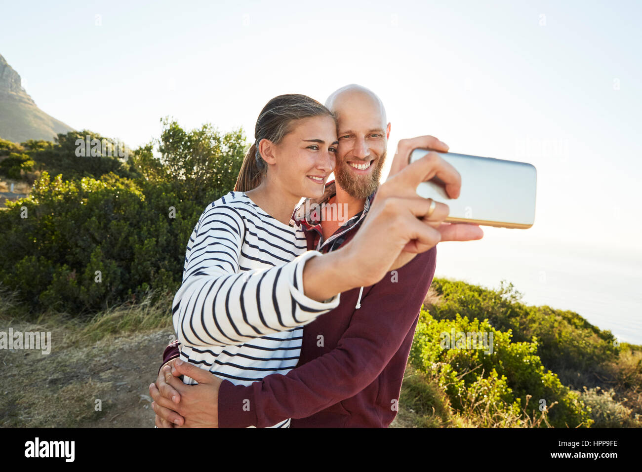 Portrait of couple in love taking selfie with smartphone Stock Photo ...
