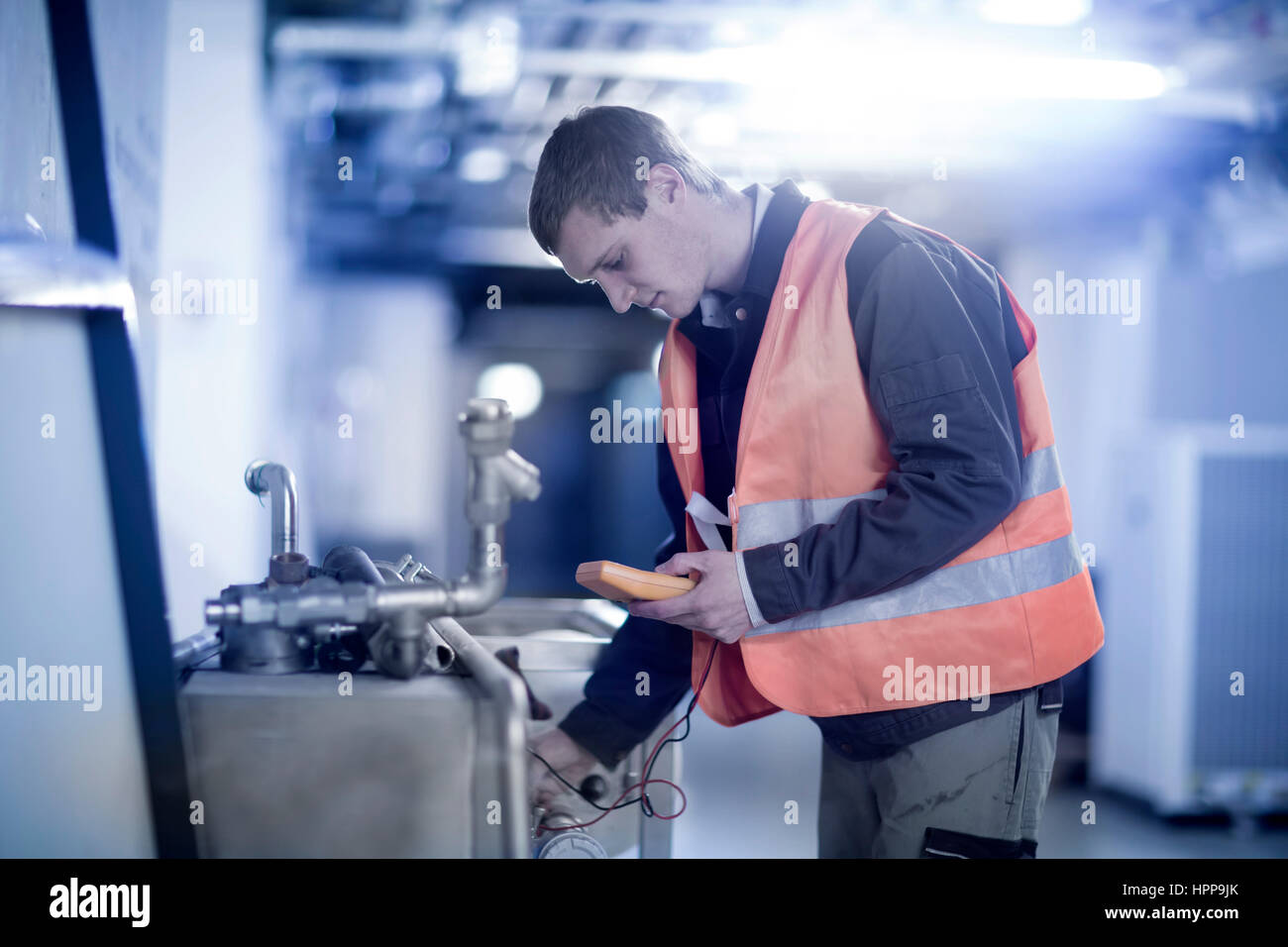 Technician with measuring device Stock Photo Alamy