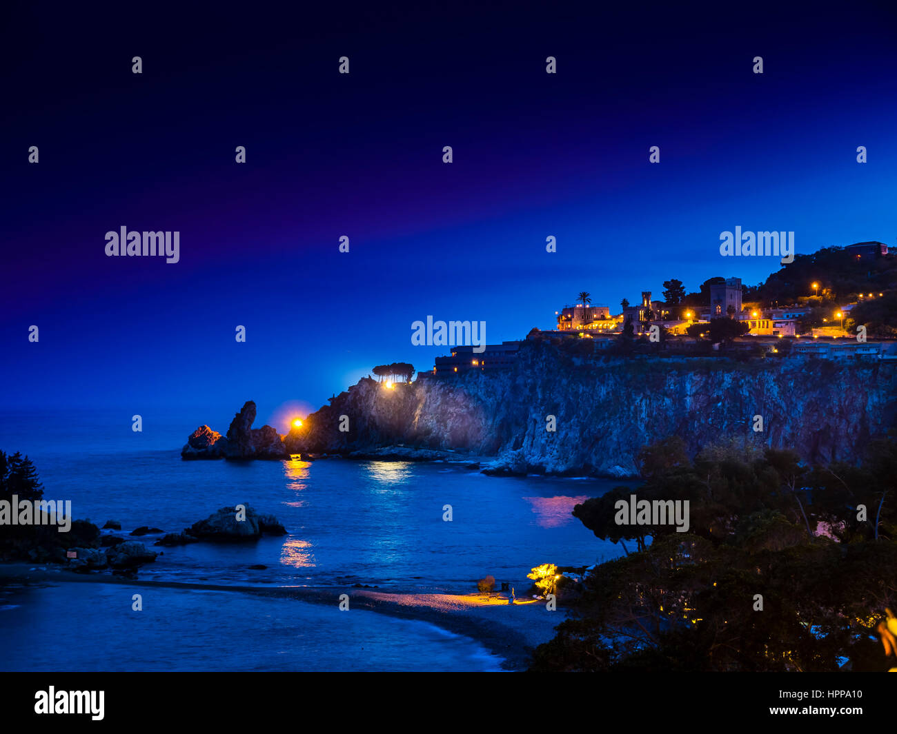 Italy, Sicily, view to bay of Giardini Naxos at night Stock Photo