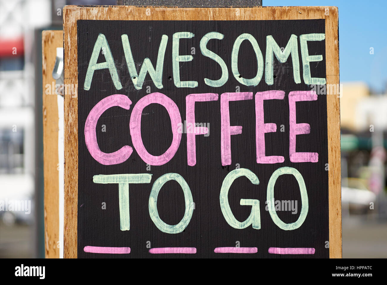 Awesome coffee to go sign - outdoor advertising with handwriting on a black chalkboard Stock Photo