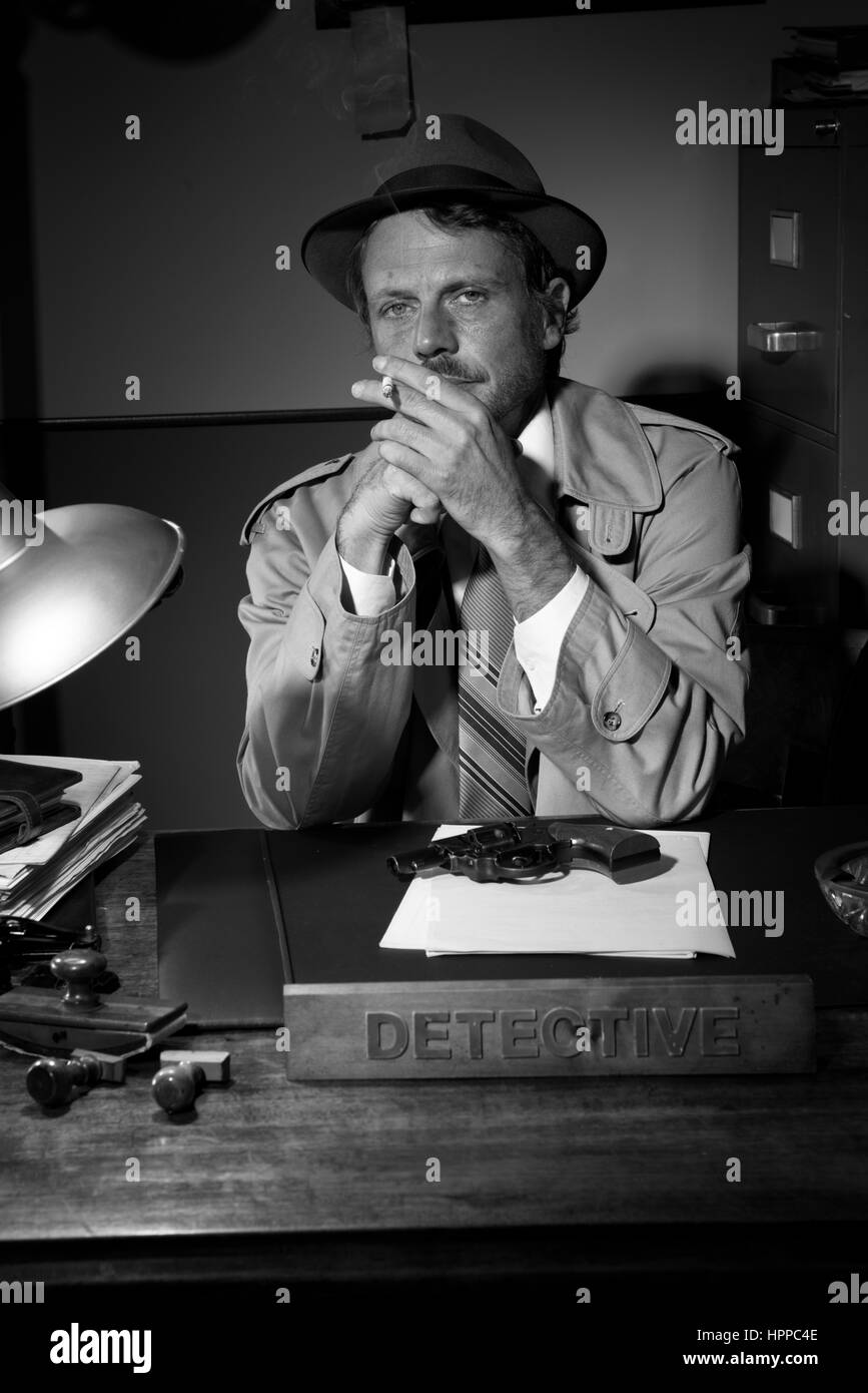 Confident detective smoking at desk in trench coat, 1950s film noir