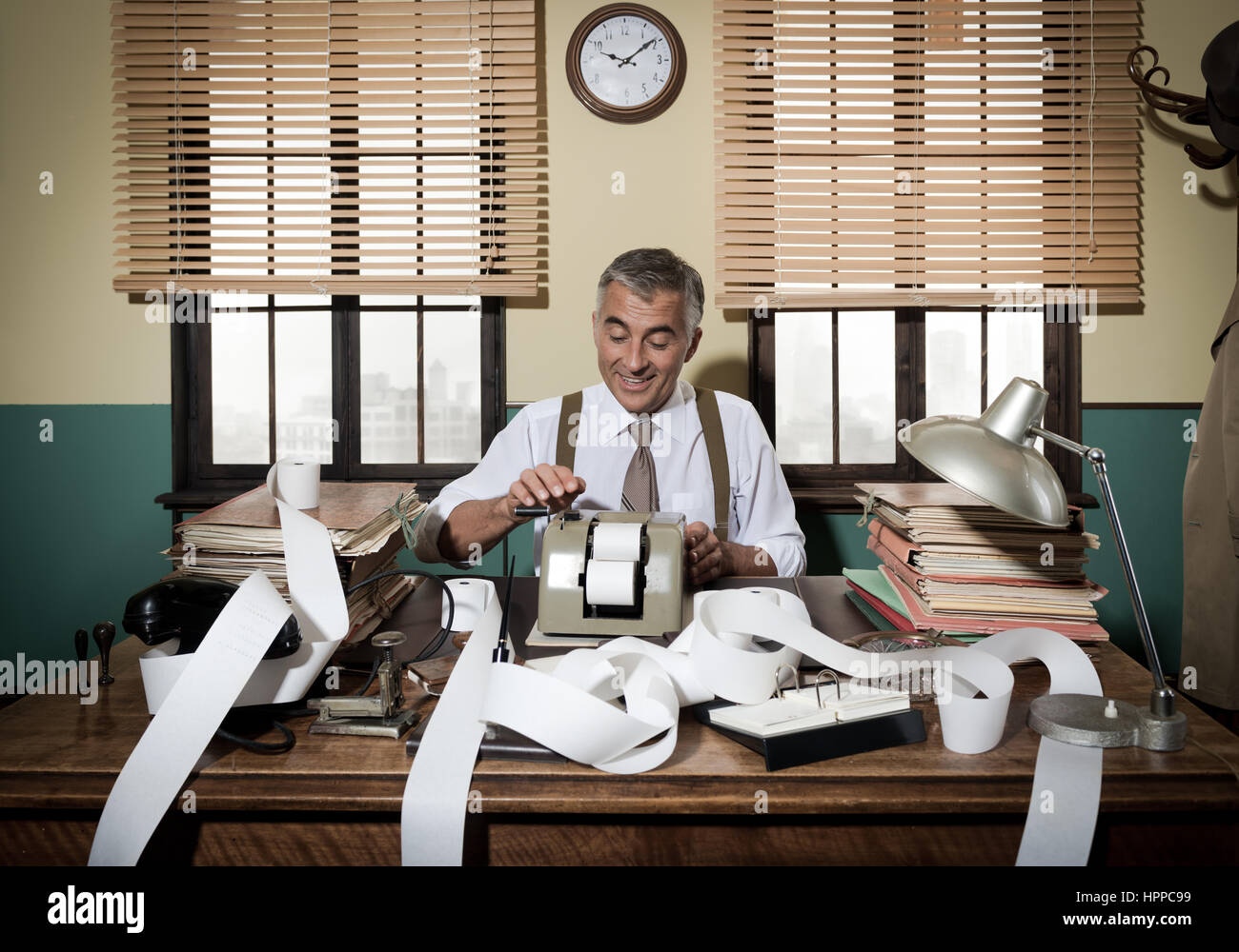 Busy vintage accountant with adding machine surrounded by cash register