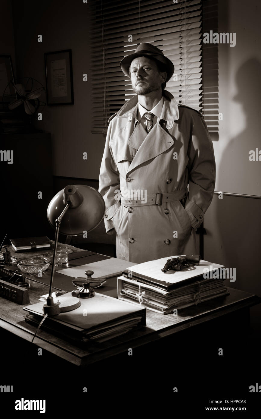 Attractive detective standing next to his desk, 1950s style office