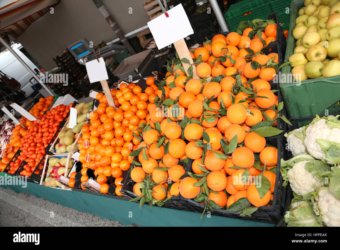 long counter in the fruit and vegetable market stall with mandarins
