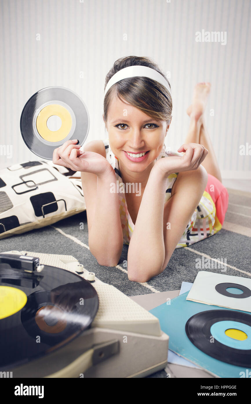 A woman listening to a turntable 1960s Stock Photo Alamy