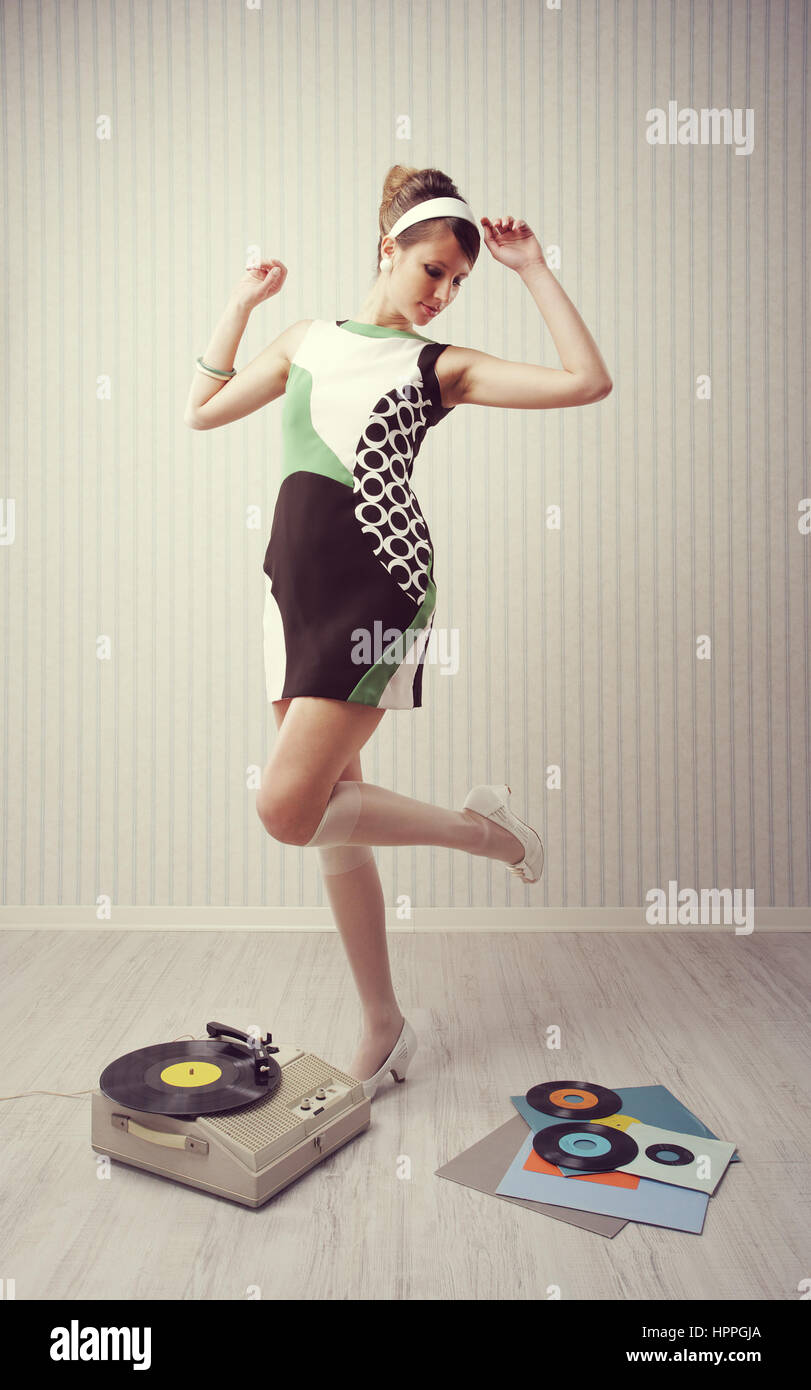 Young woman dancing at home, 1960 style Stock Photo