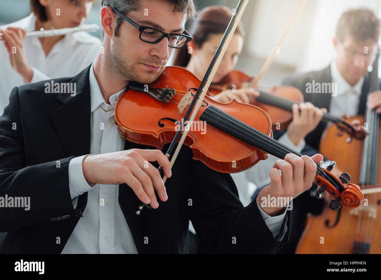 Classical music symphony orchestra string section performing, male ...