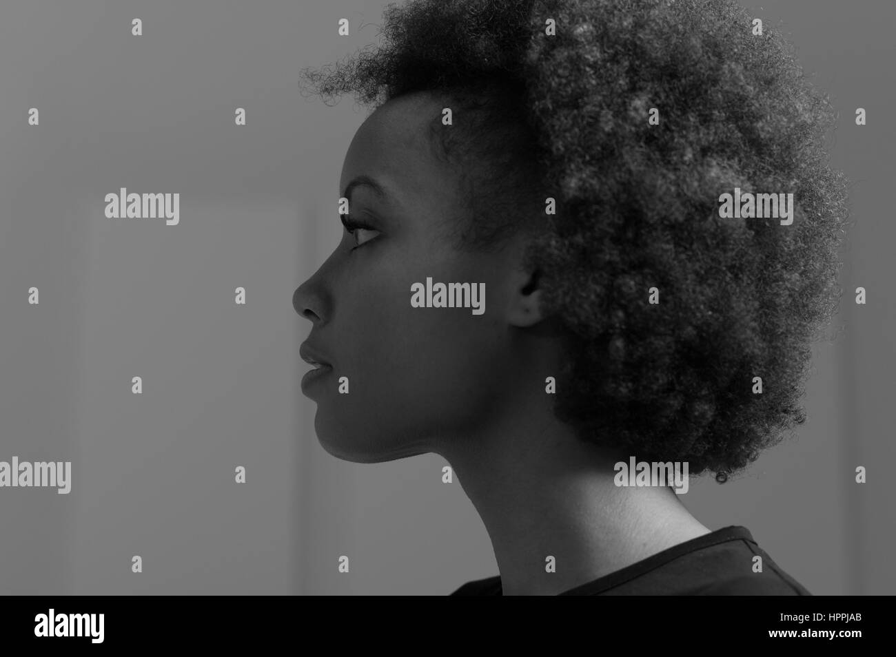 Beautiful young african american woman posing, she is looking away ...