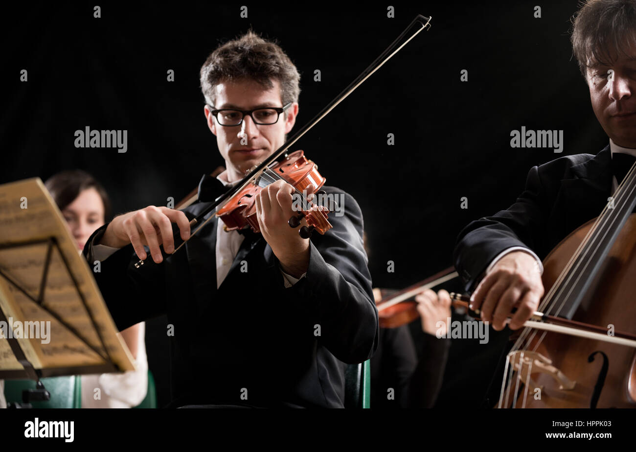 String orchestra performing on stage hires stock photography and
