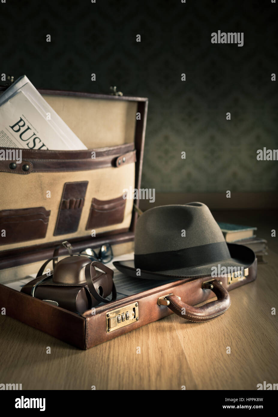 Photoreporter vintage open briefcase with old camera, newspaper and