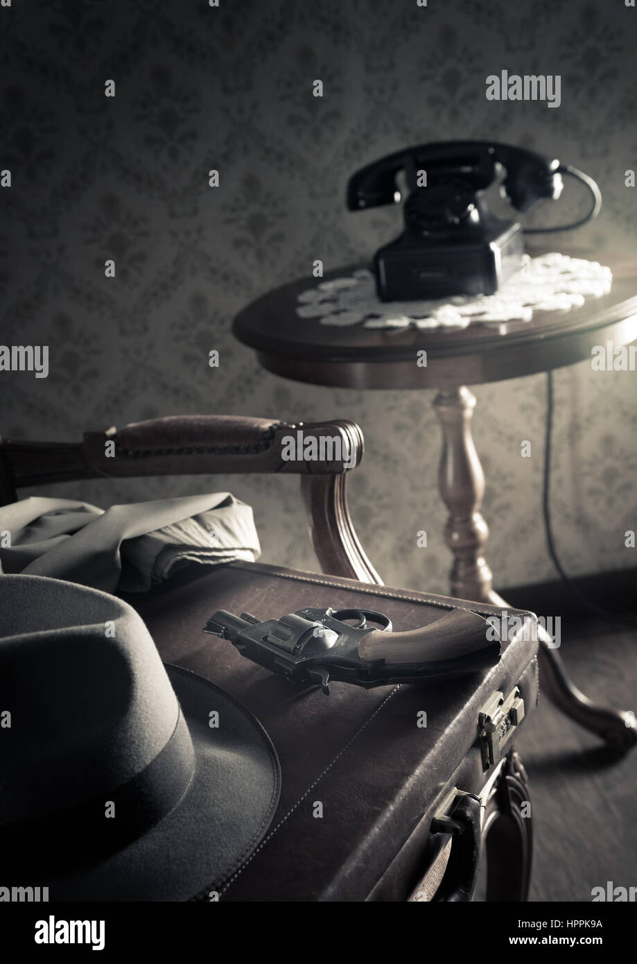Detective equipment with briefcase, hat and gun, vintage interior on